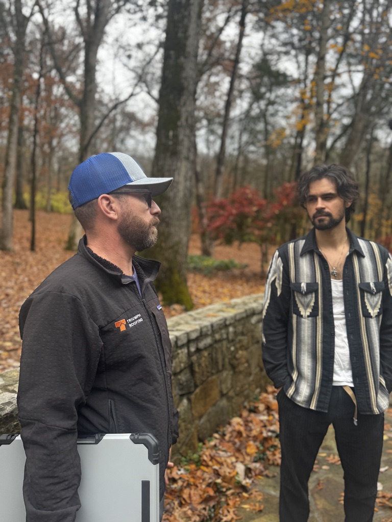 Triumph roof tech reviewing storm damage with homeowner